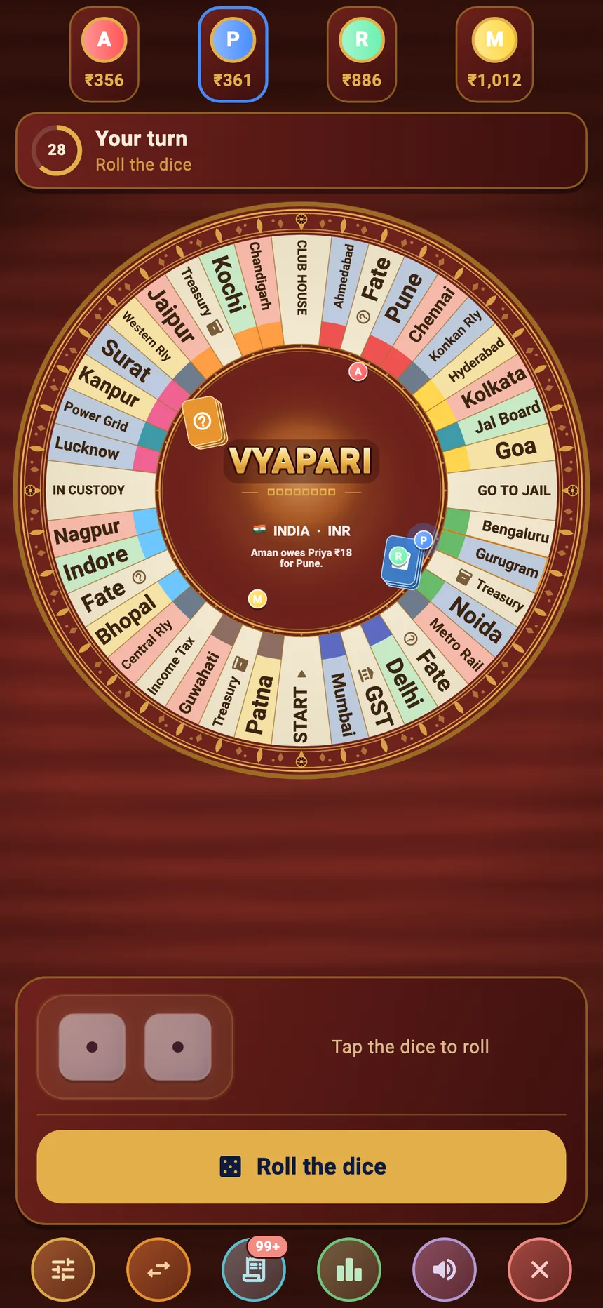 The circular board mid-game, with four players and the dice ready to roll